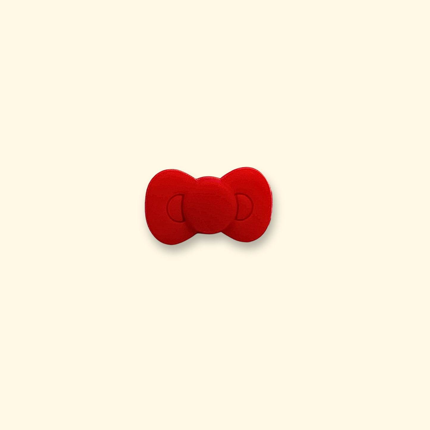 A cute red Christmas bow charm, a perfect addition to your pet's collar for a festive touch.