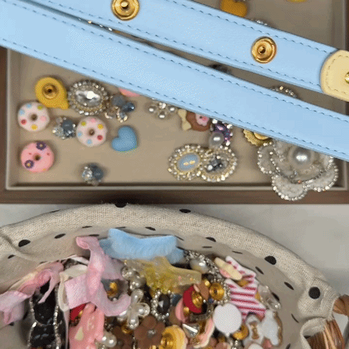 Hands attaching interchangeable charms onto a butter yellow and sky blue dog leash