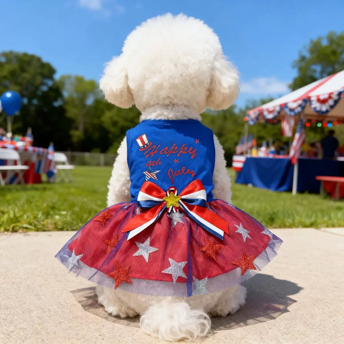 Back view of a small dog wearing an America250 themed pet dress with patriotic bow and red star tutu skirt