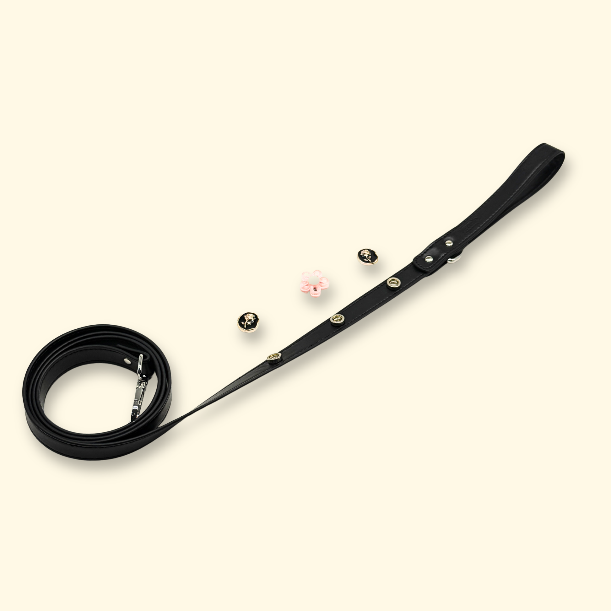 Black dog leash laid flat showing interchangeable charm snap design and adjustable length