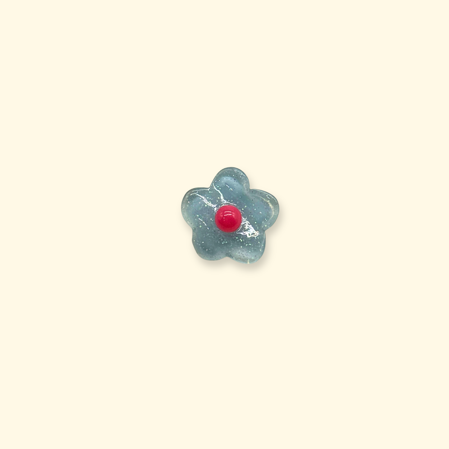 A single blue floral snap-on charm with a red center, designed for dog collars as a pastel-style interchangeable pet accessory.