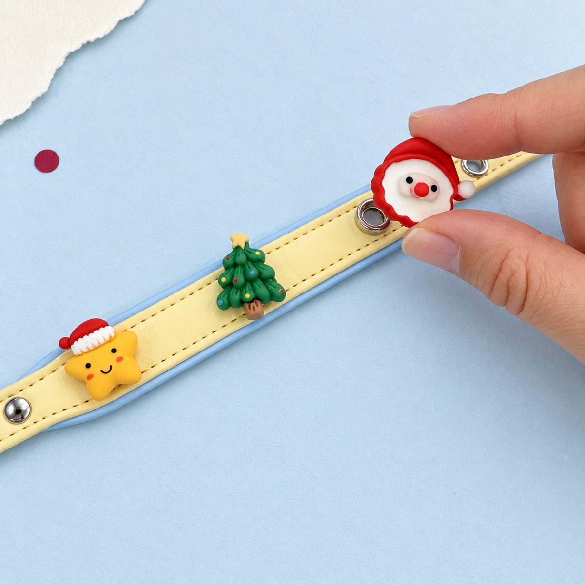 Santa charm being attached to a Petiria collar to create a personalized Christmas dog collar with interchangeable charms