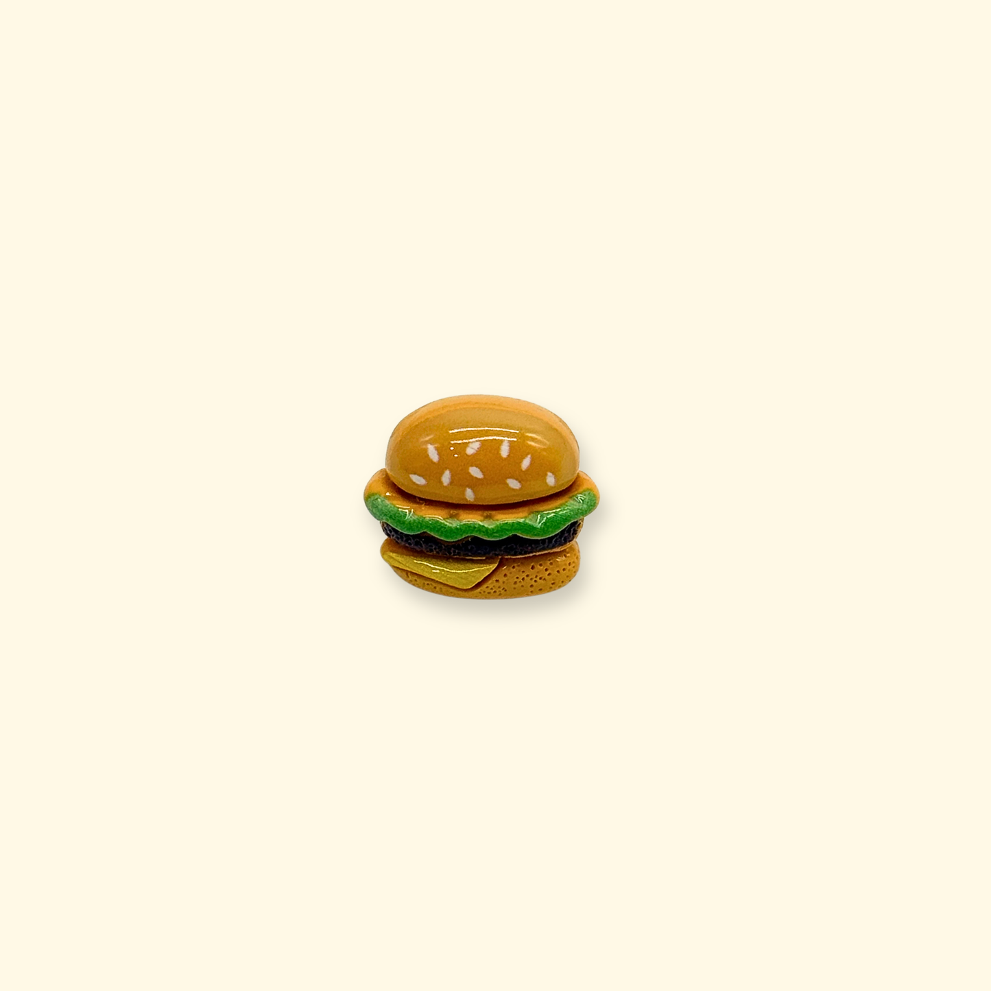 Mini burger shaped dog collar charm designed for snap-on interchangeable pet collars, food themed pet accessory for cute personalized dog styling.