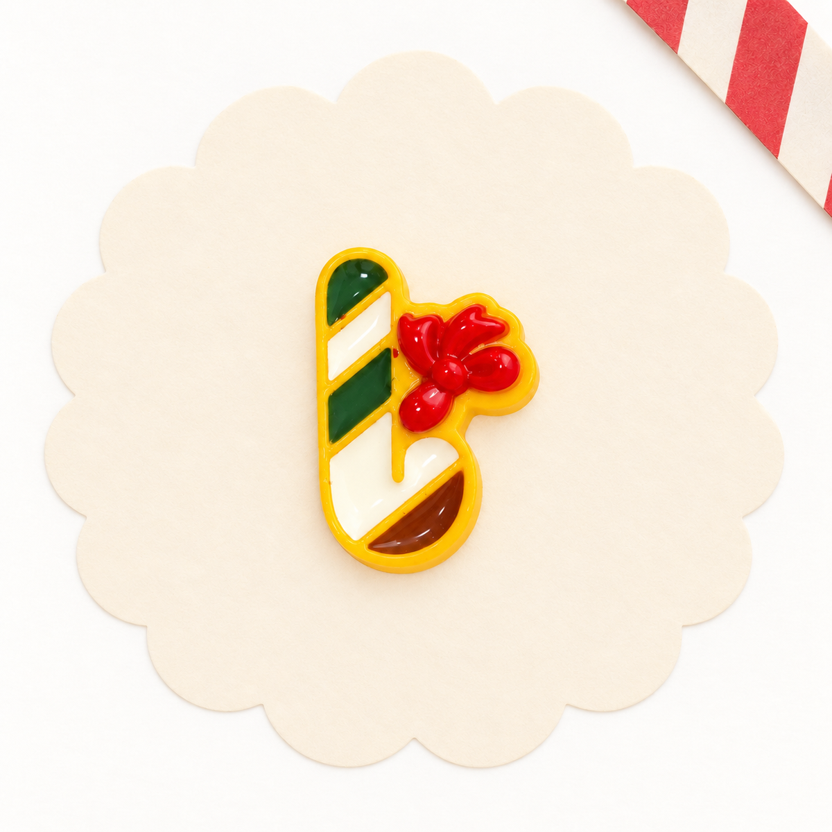 Christmas candy cane dog collar charm with green and white stripes and a red bow for festive pet styling