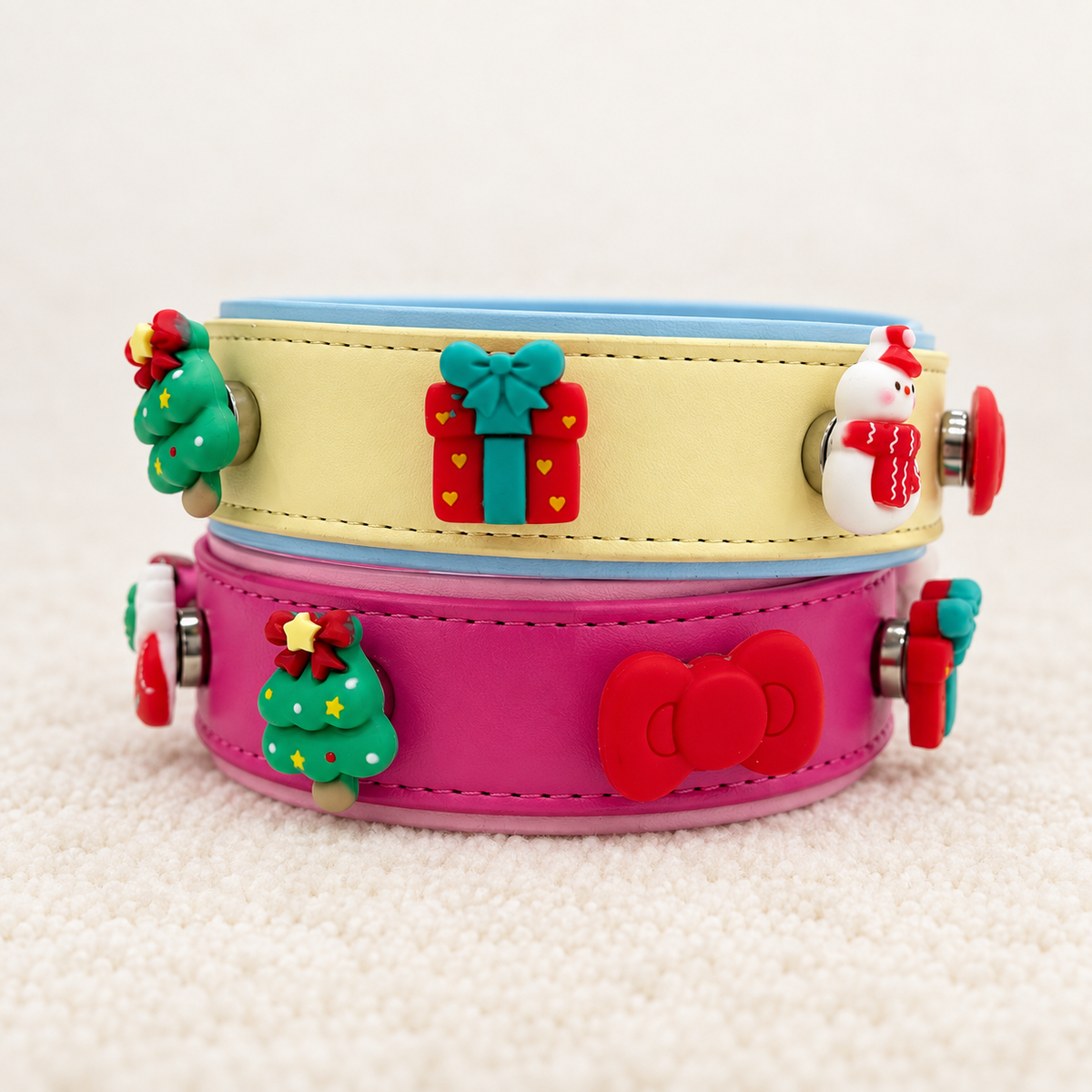 Cream and pink Christmas dog collars styled with gift box, tree, snowman, bow and festive snap-on charms