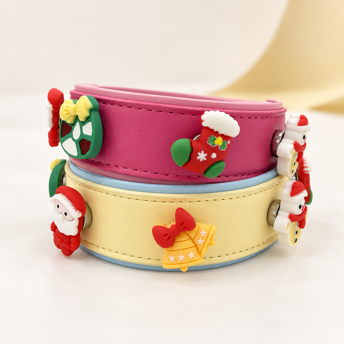 Pink and cream Christmas dog collars with bells, Santa, wreath, stocking and interchangeable charms for a personalized festive look