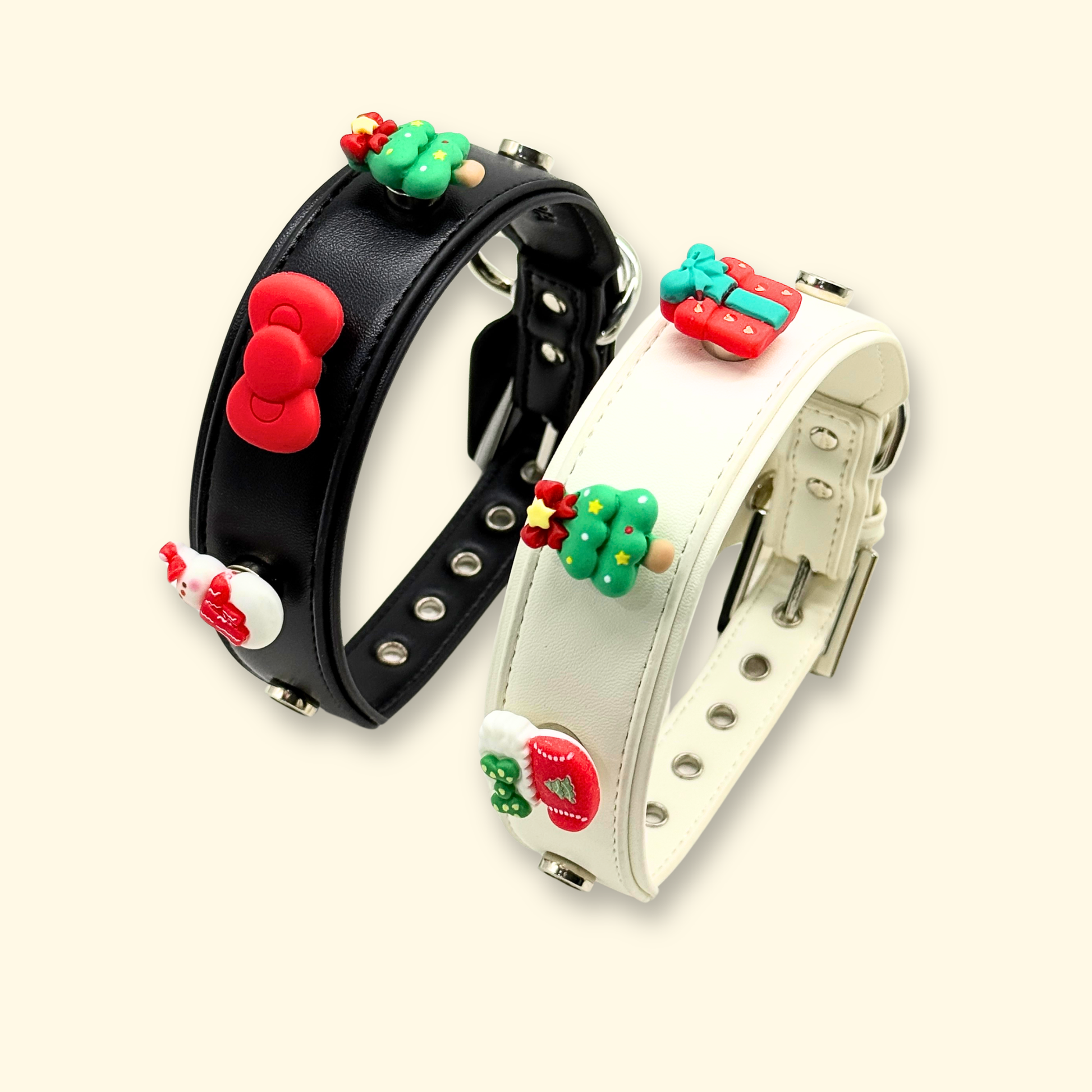 A display of two pet collars, one with a red bow and the other with Christmas-themed charms, perfect for the holidays.
