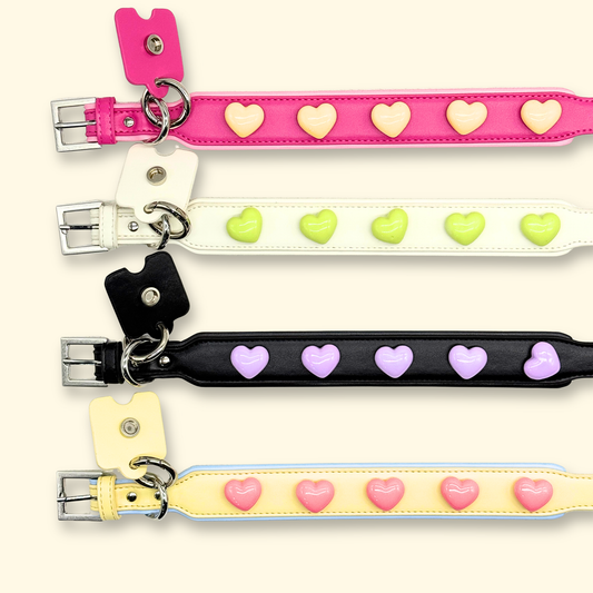 Custom dog collars with pastel heart charms in pink, black, cream, and yellow color combinations for aesthetic pet styling