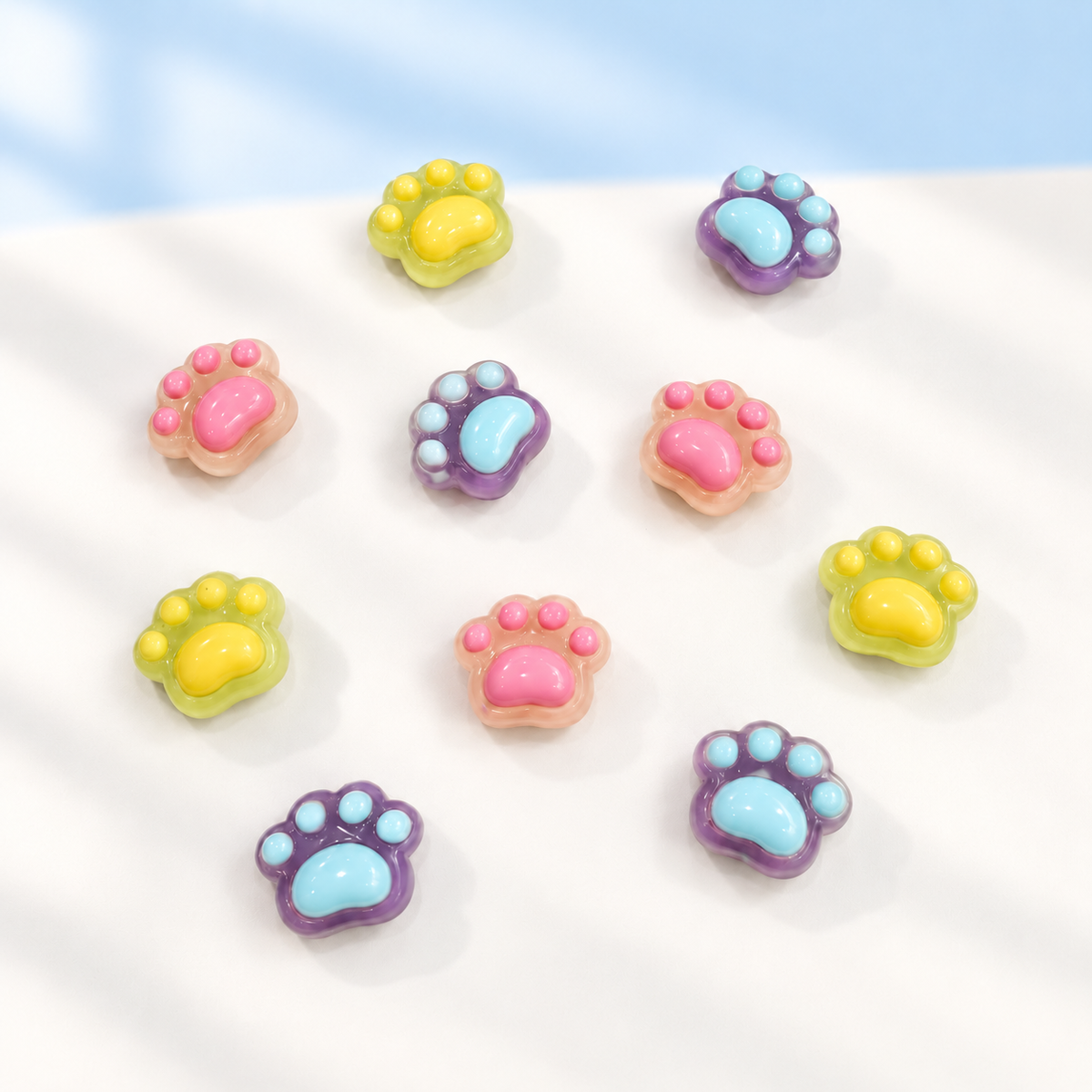 Colorful paw print dog collar charms in pink, yellow, blue and purple designs
