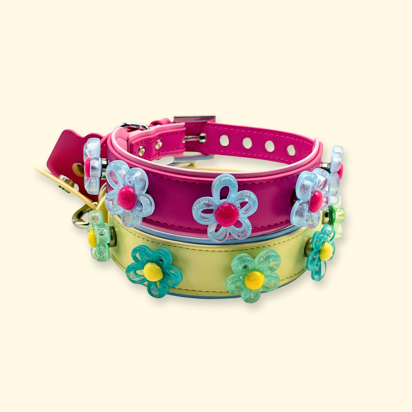 Two pastel dog collars styled with interchangeable flower charms, showing cute mix-and-match pet collar accessory ideas for dogs