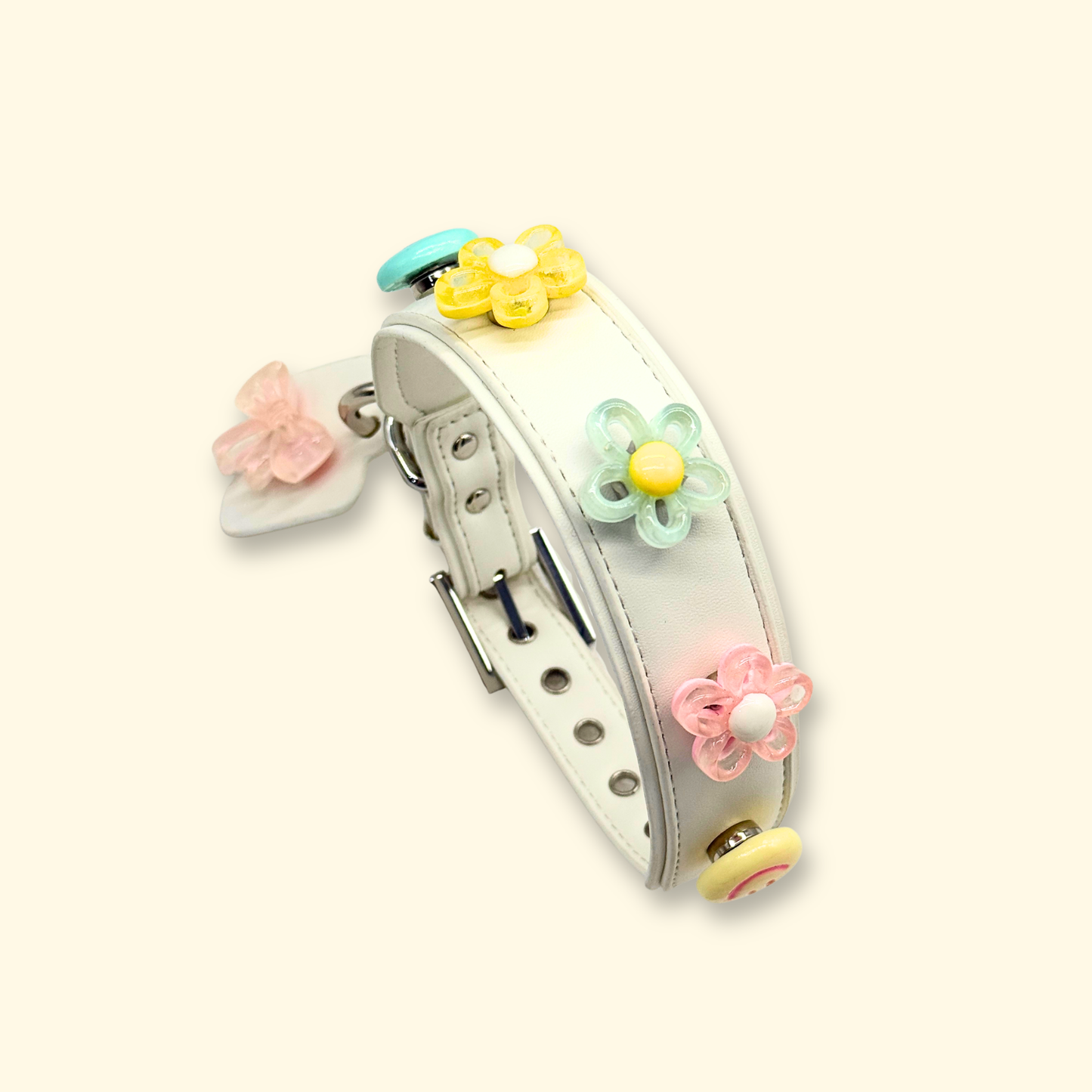 White leather pet collar adorned with vibrant yellow, green, and pink flower charms for a playful touch