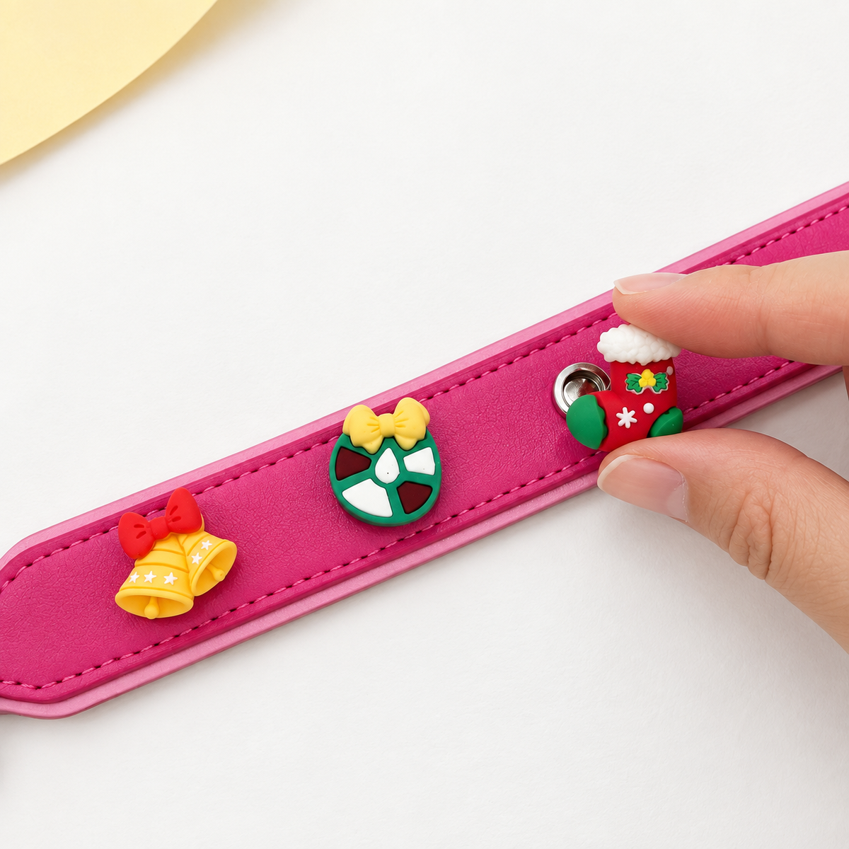 Christmas stocking charm being snapped onto a Petiria collar to DIY a personalized Christmas dog collar with interchangeable charms