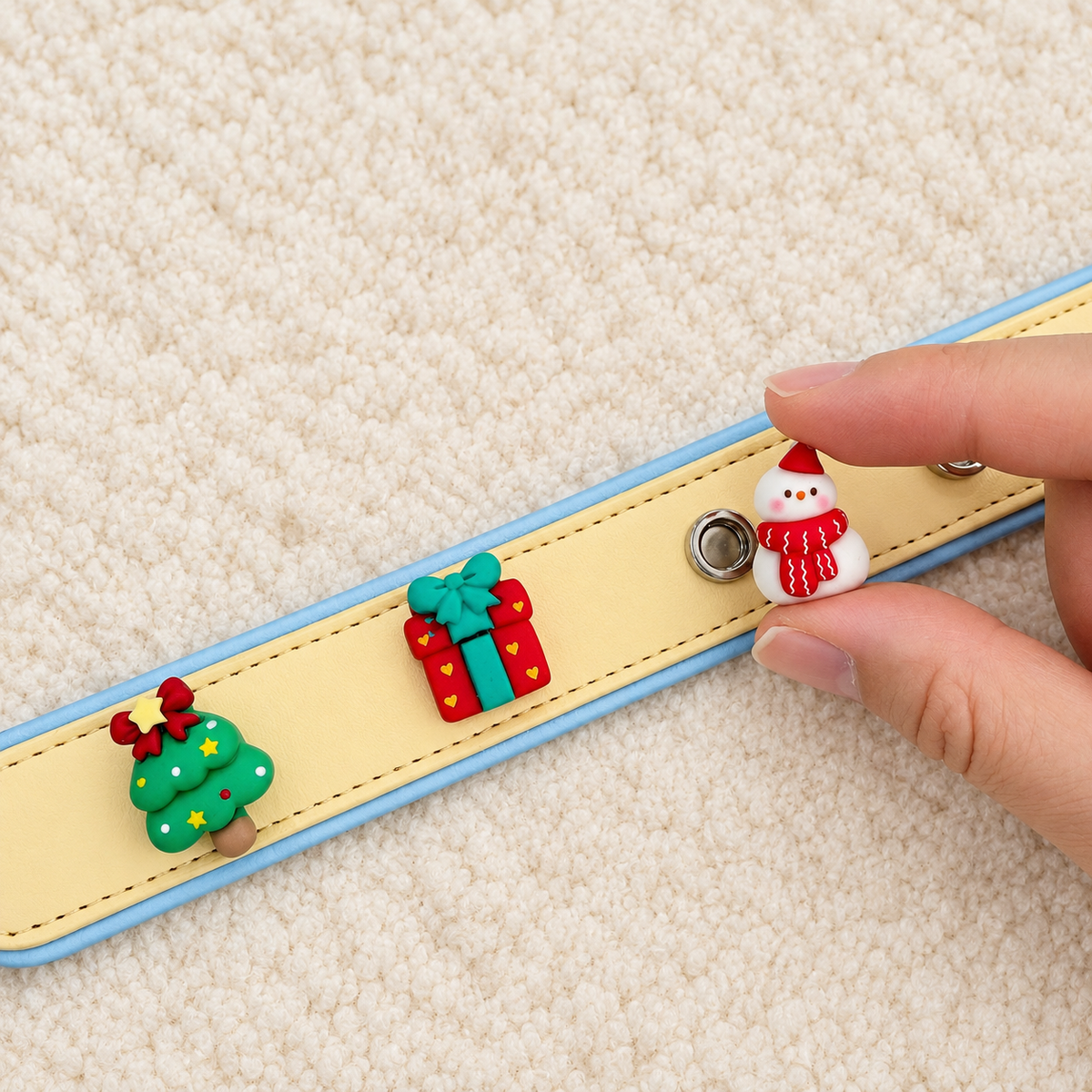 Christmas charm being attached to a Petiria collar to DIY a personalized Christmas dog collar gift look