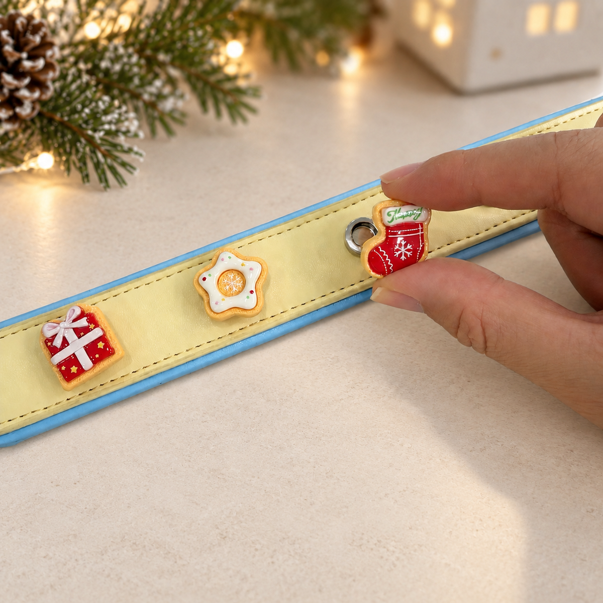 Christmas cookie dog collar charm being snapped onto a Petiria interchangeable charm collar for festive styling