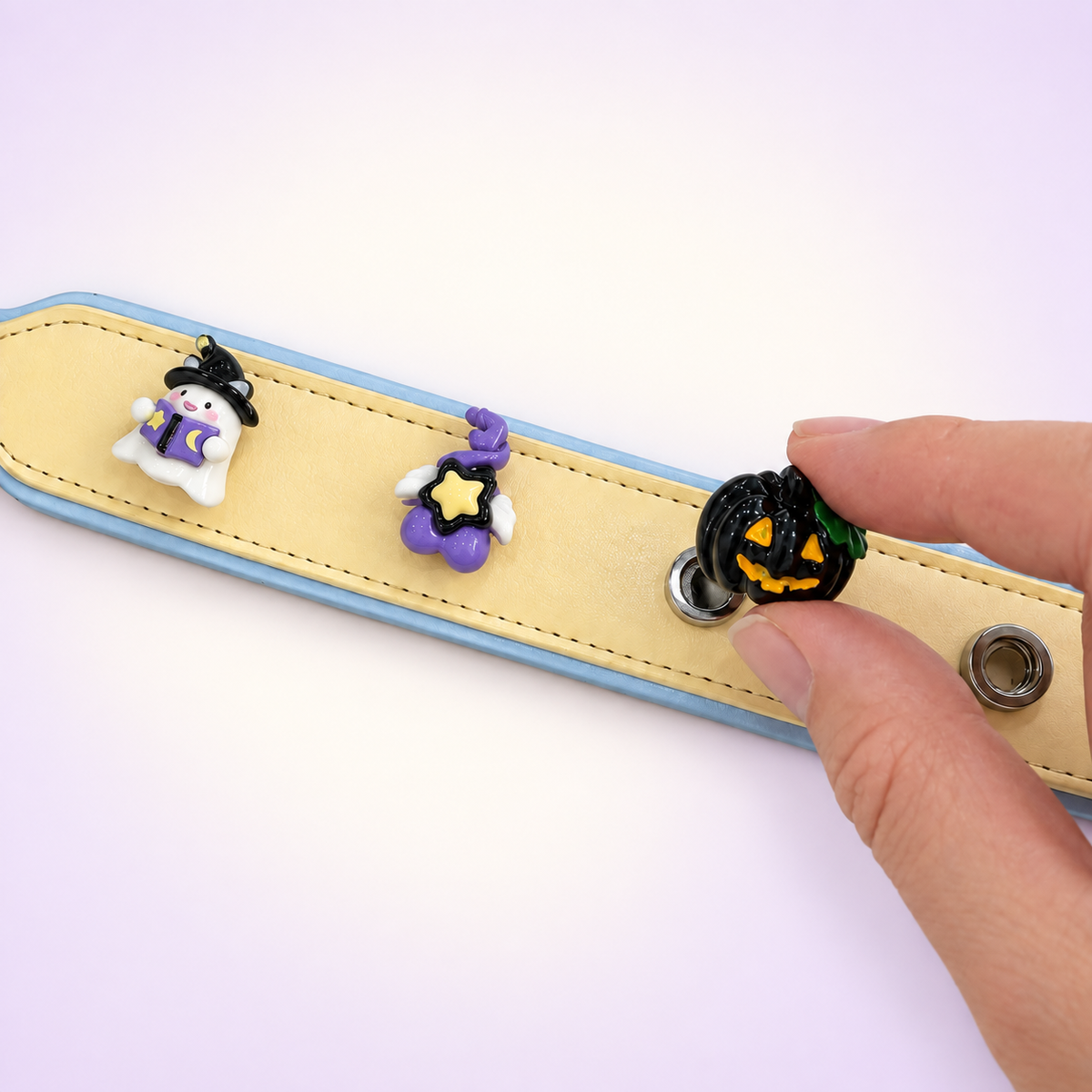 Witchy Halloween dog collar charms being snapped onto a Petiria interchangeable charm collar