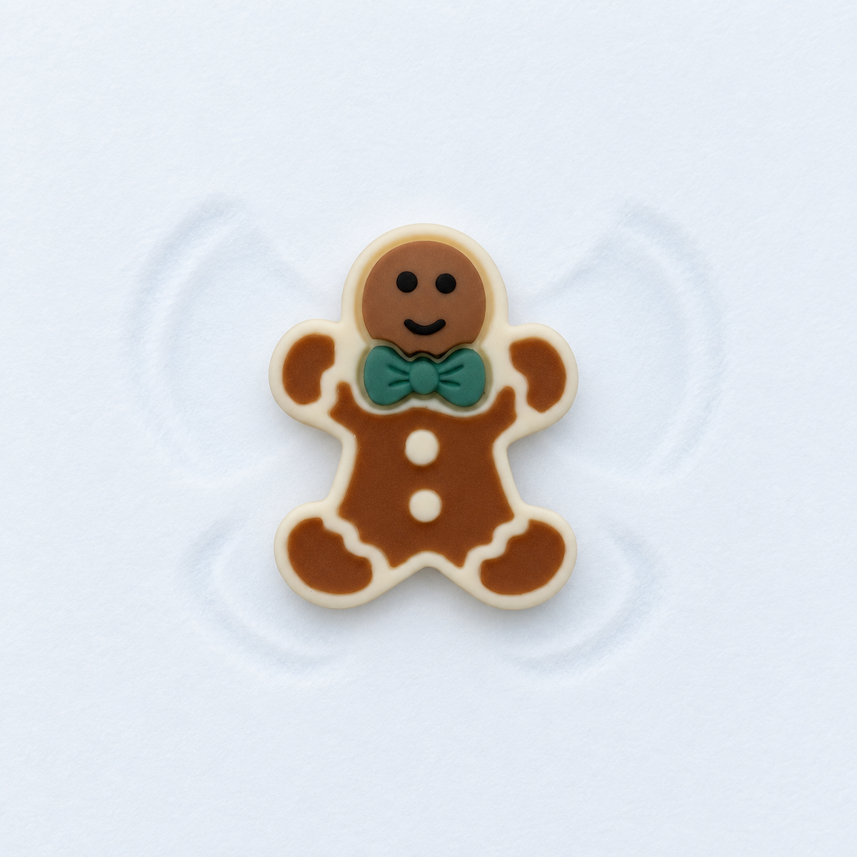 Gingerbread man dog collar charm with white icing details and a green bow for festive Christmas styling