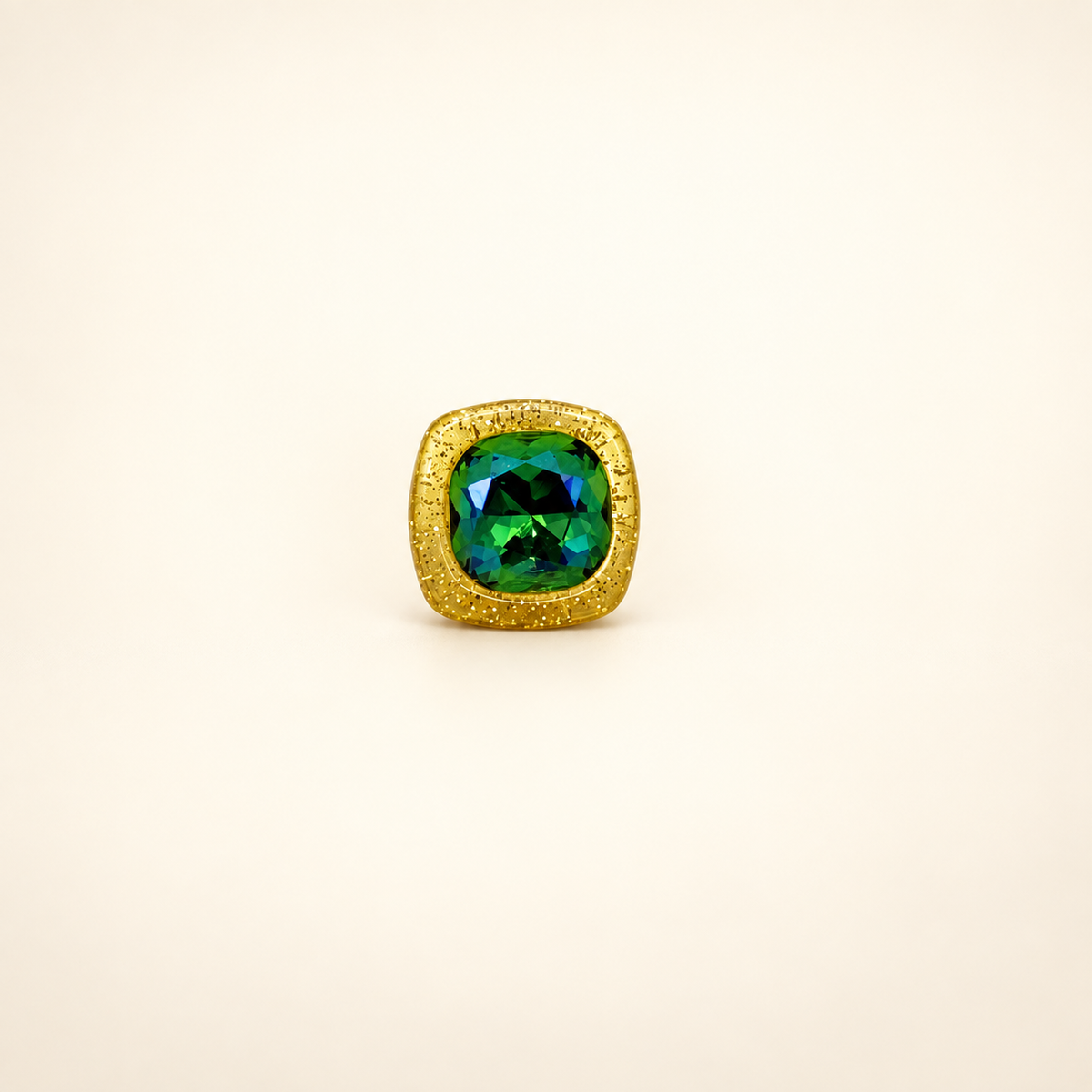 Gold-frame dog collar charm with a faceted green gem center and sparkling jewelry-inspired finish
