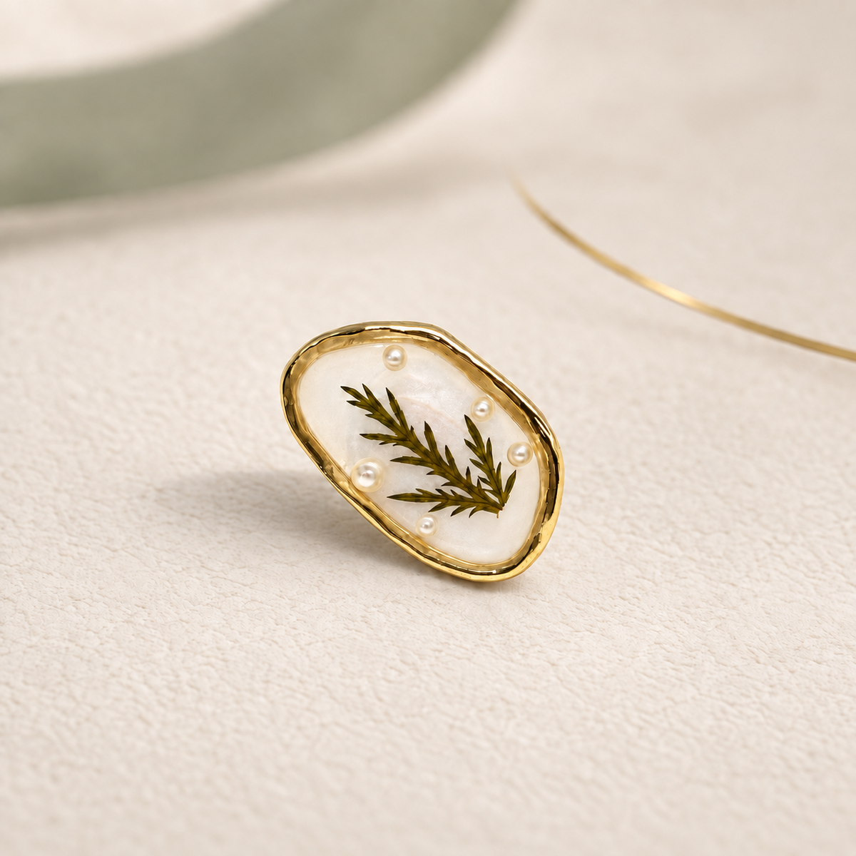 Golden Fern dog collar charm with a delicate botanical leaf design and vintage gold-tone oval frame