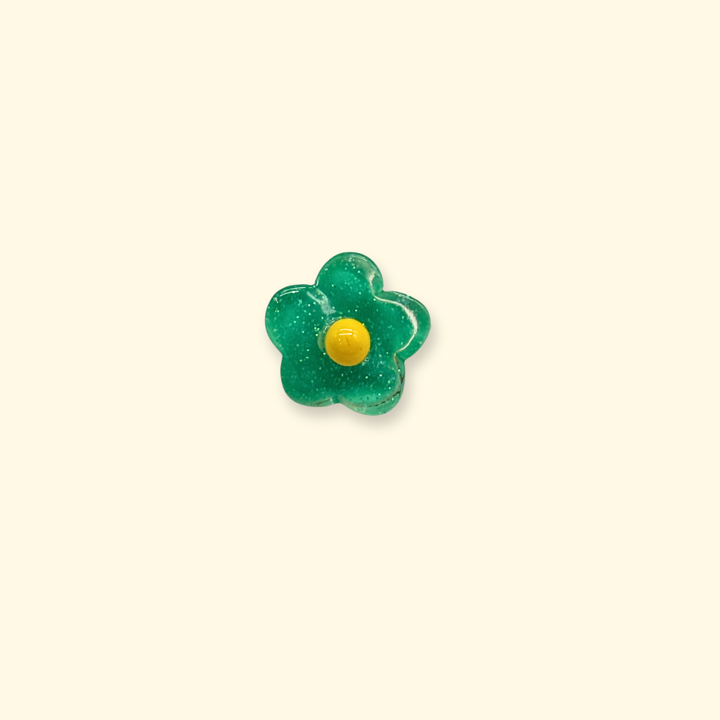 A green floral snap-on dog collar charm with a yellow center, designed for customizable pet collar decoration.