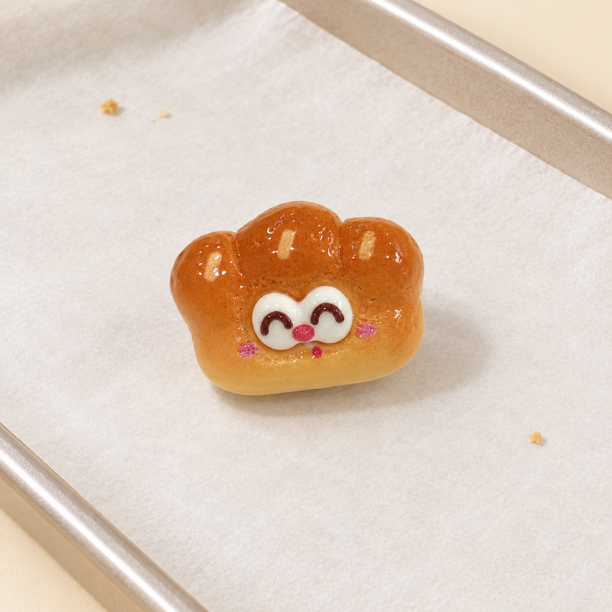 Happy Bread Roll dog collar charm with a golden baked finish and cute smiling face