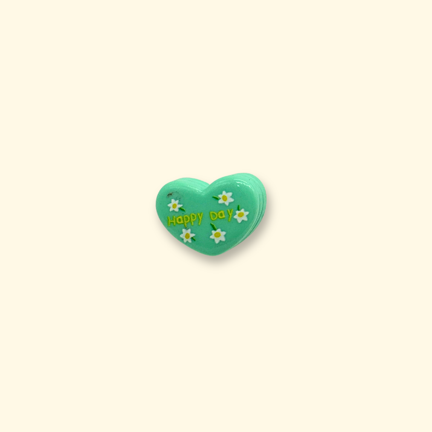 Green heart-shaped charm with flowers and 'Happy Day' text for pet collars