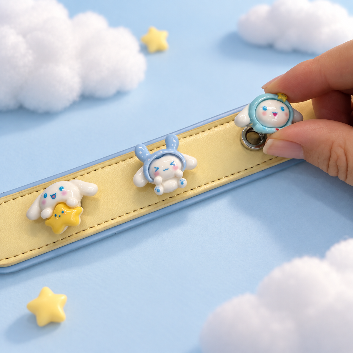 Hand attaching an interchangeable pastel bunny dog collar charm to a yellow PETIRIA collar