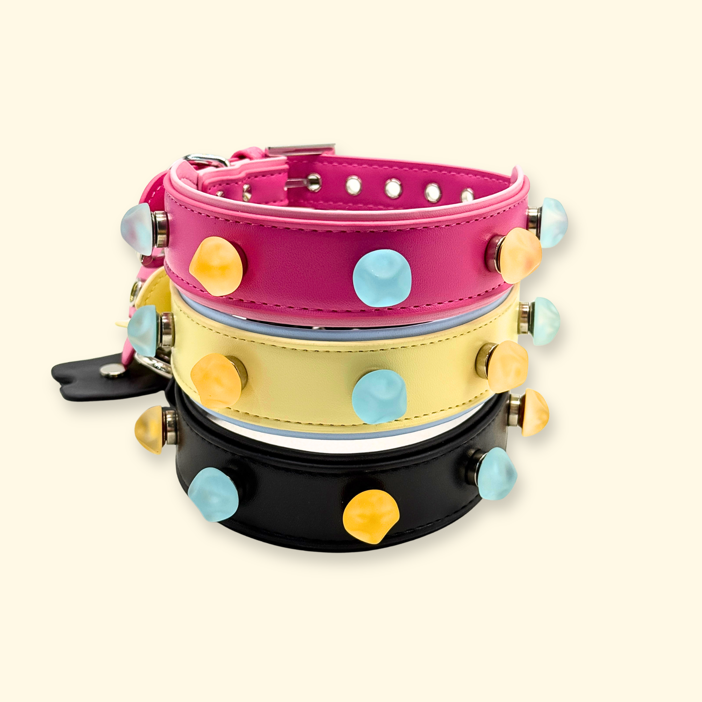 Stacked pink, yellow, and black dog collars with snap-on colorful charms, modular pet collar system for mix-and-match customization