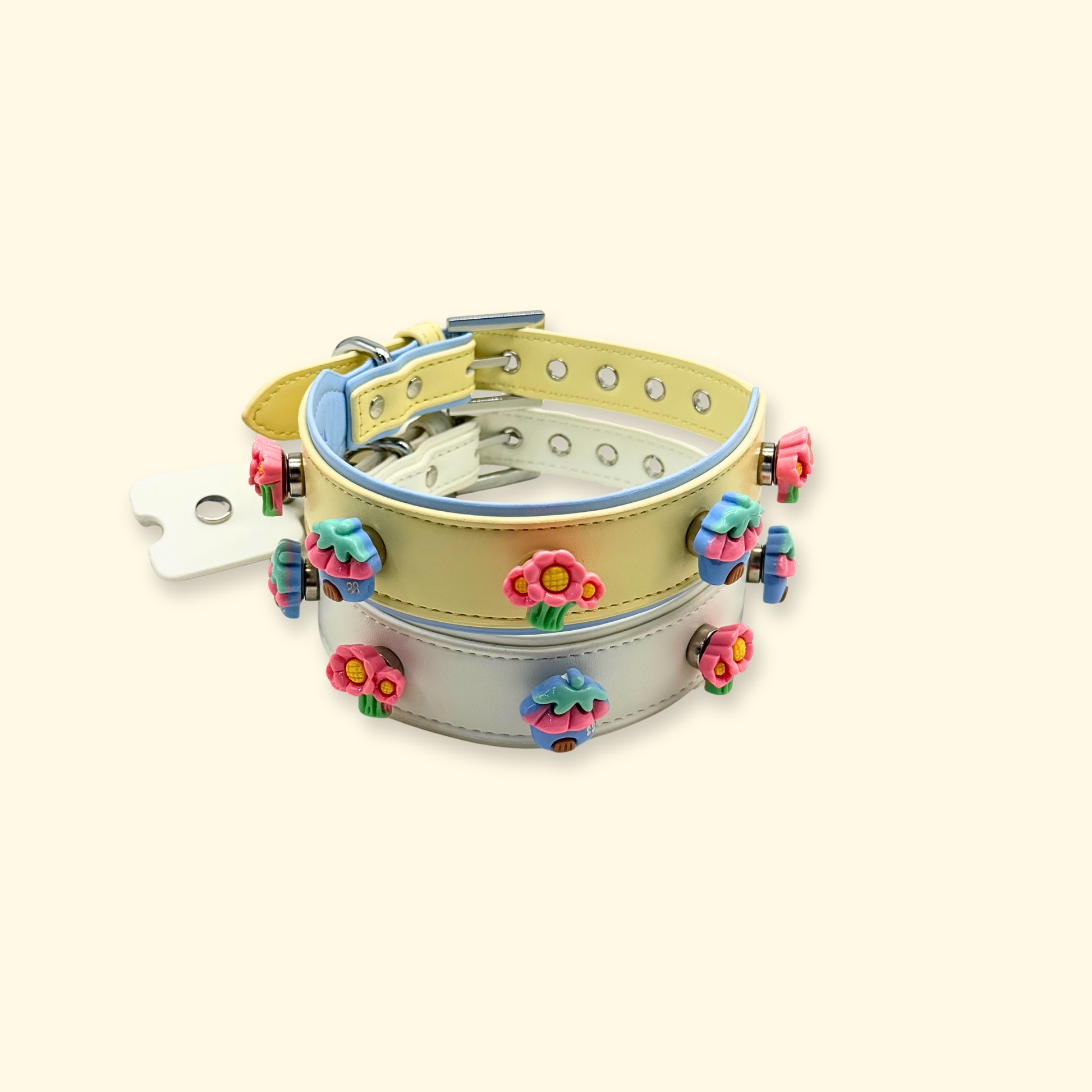 Stacked set of adjustable dog collars with colorful floral snap-on charms in kawaii style, pet accessory collection display on neutral background