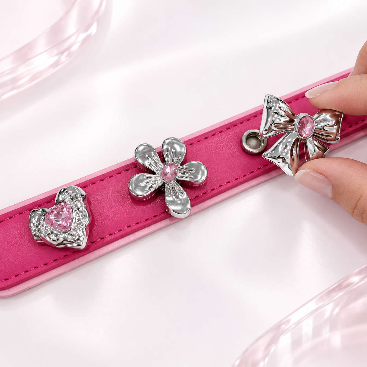 Hand styling interchangeable pink crystal dog collar charms on a pink PETIRIA collar