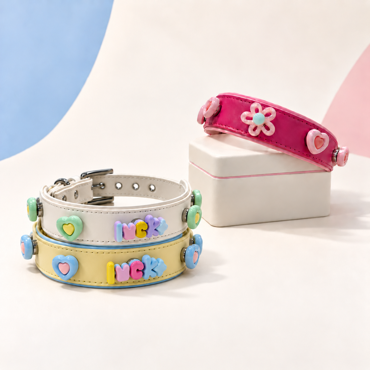 Lucky Love dog collar charms styled on pink, white and yellow Petiria interchangeable collars