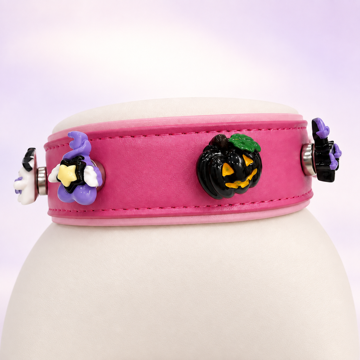 Pink Petiria collar styled with witchy ghost, black jack-o-lantern and magical Halloween dog collar charms