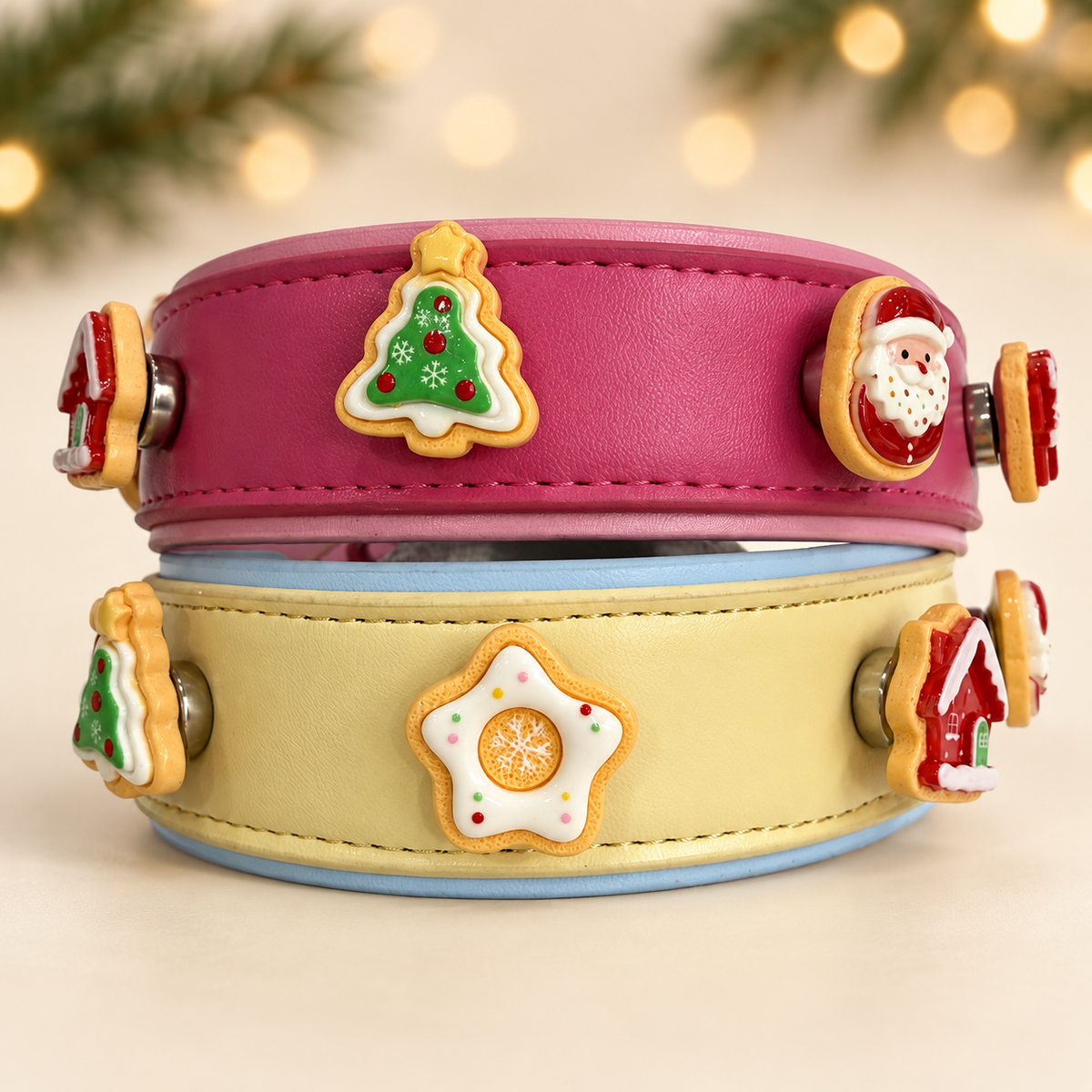 Pink and cream Petiria collars styled with Santa, Christmas tree, star and other festive cookie dog collar charms