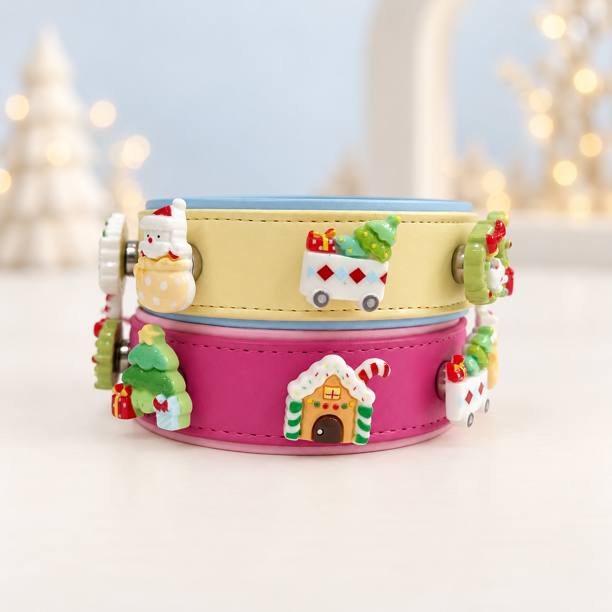 Cream and pink Petiria collars styled with colorful Christmas dog collar charms including Santa, tree, wreath and holiday house designs