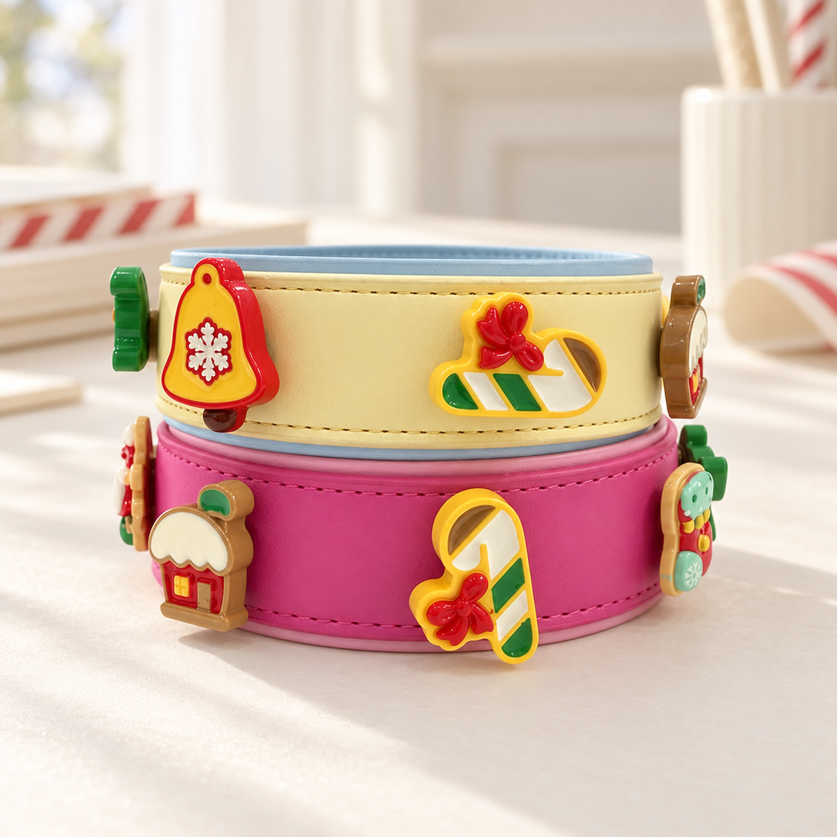 Cream and pink Petiria collars styled with Christmas bell, candy cane, stocking, ice skate and holiday house charms