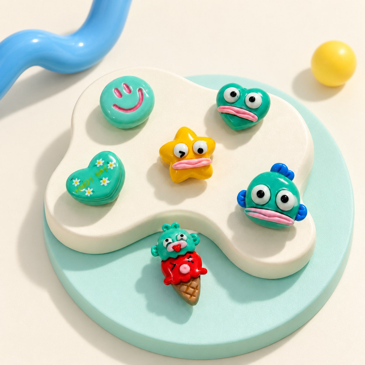 Colorful fish, star and smiley face dog collar charms displayed in a playful mix-and-match collection