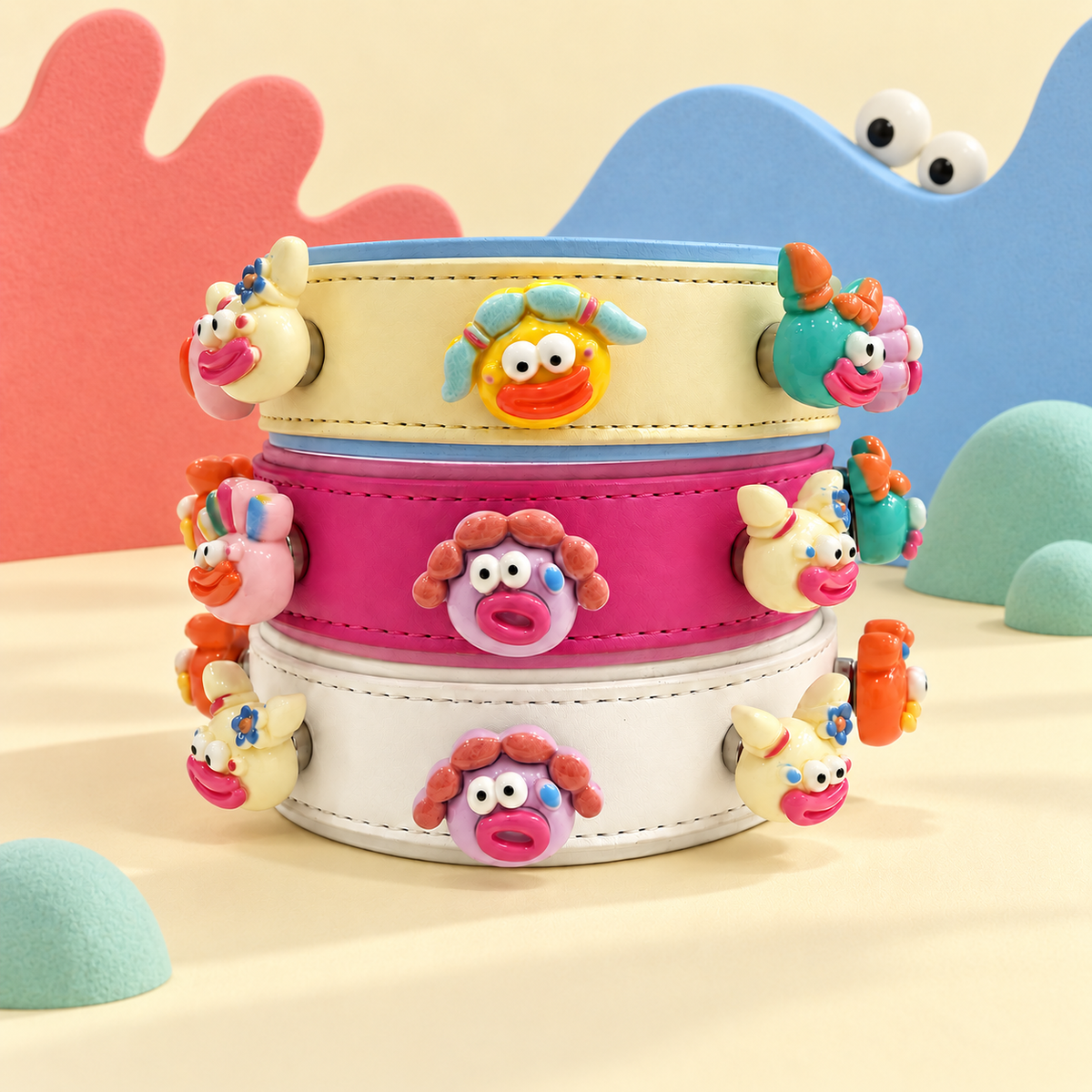 Colorful monster dog collar charms mixed and matched on yellow, pink and cream Petiria collars