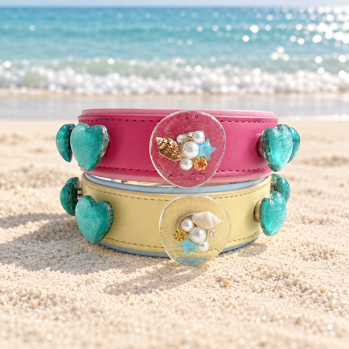Ocean dog collar charms with turquoise heart and seaside-inspired designs styled on pink and yellow PETIRIA collars