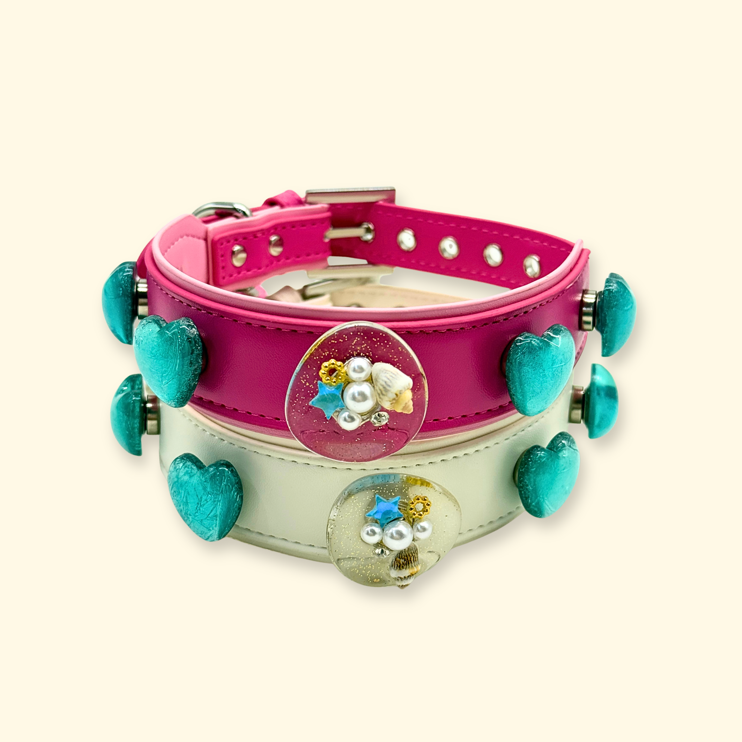 Pink and cream dual dog collar charm set with ocean heart and shell resin accessories, styled on small breed dogs for summer aesthetic look