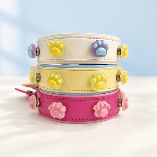 Paw print dog collar charms styled on cream, yellow and pink Petiria interchangeable collars