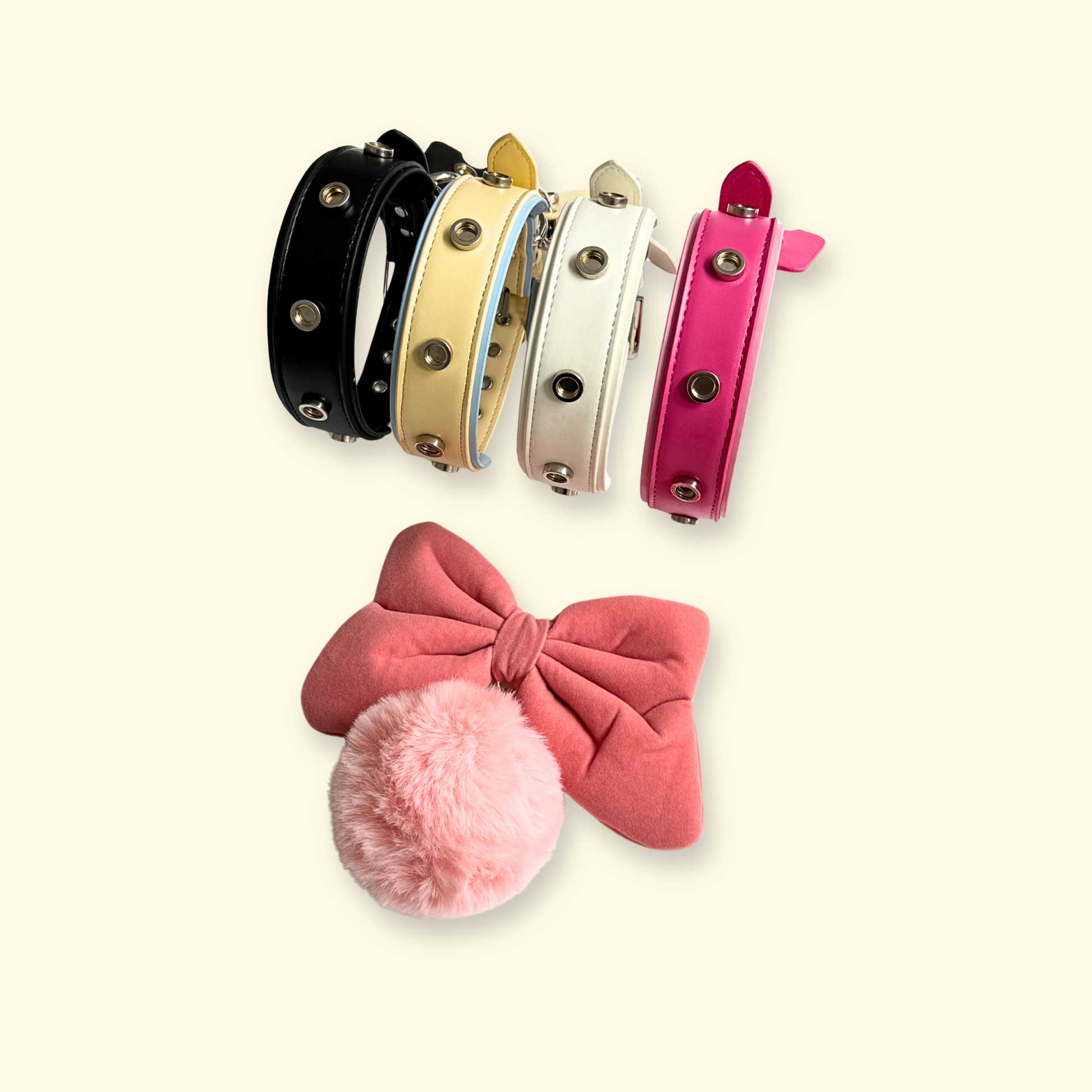 Pink flocked bow and pom charm shown with PETIRIA interchangeable dog collars in multiple colors