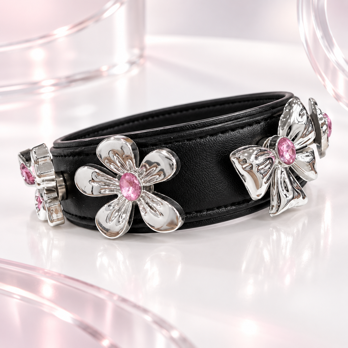 Black PETIRIA collar styled with silver-tone pink crystal dog collar jewelry including flower and bow designs