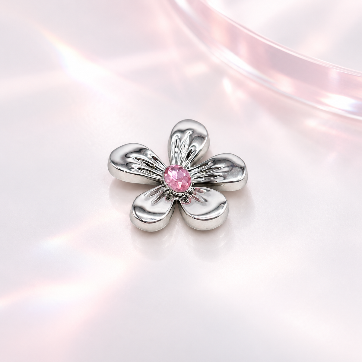 collar charm with silver-tone petals and a sparkling pink crystal center