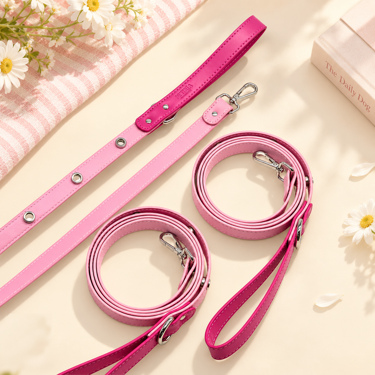 Pink PETIRIA dog leashes showing interchangeable charm attachment points, metal hardware and loop details