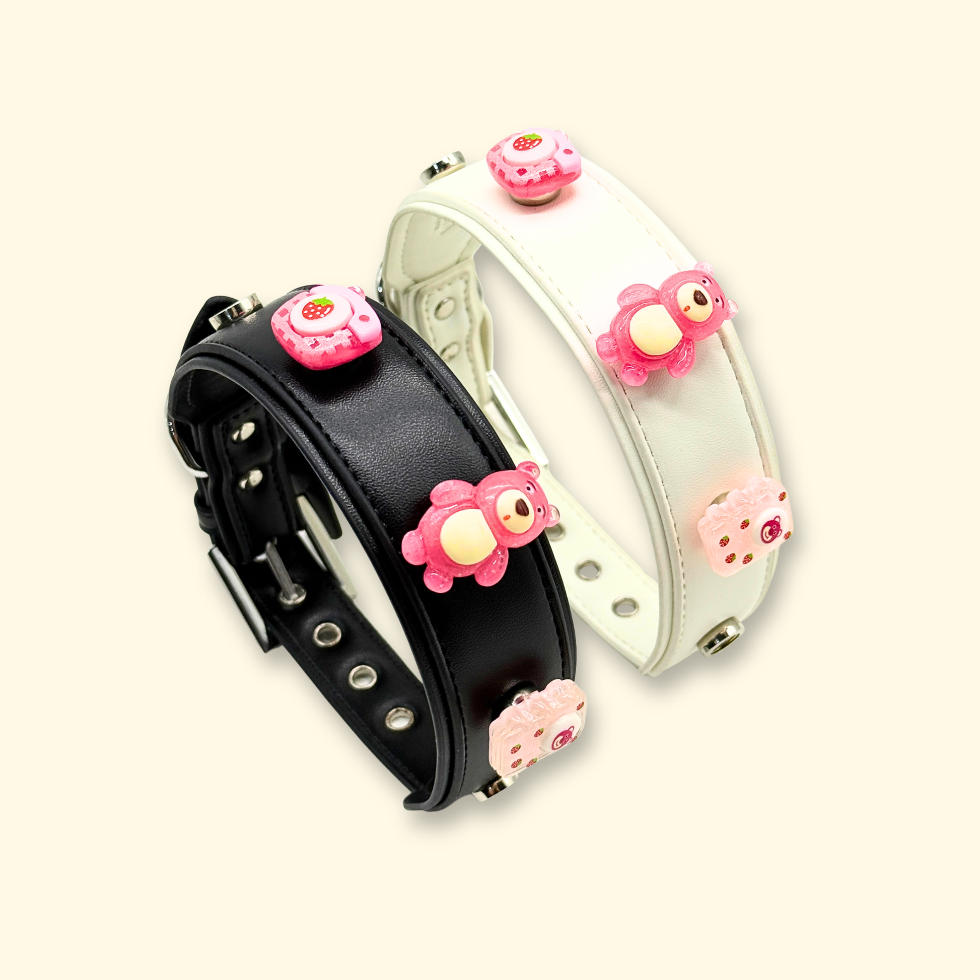 pink bear and strawberry charms styled on black and white pet collars for dogs and cats
