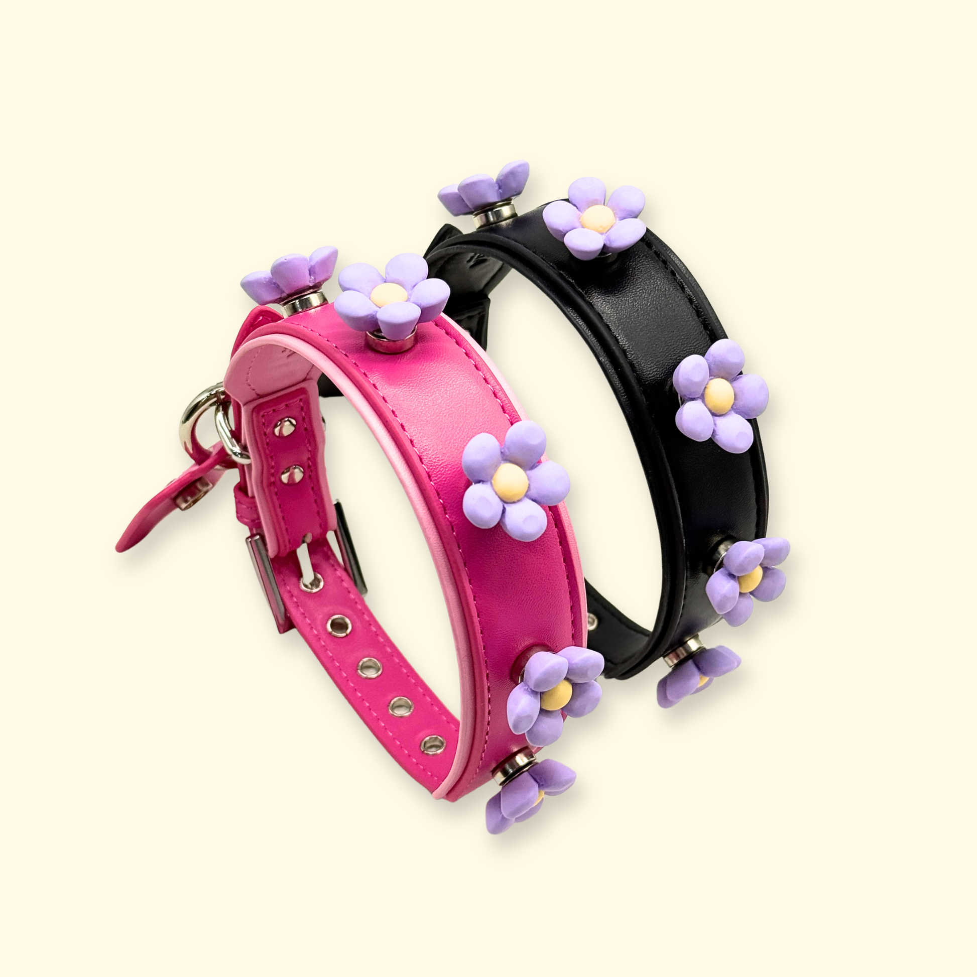 Pink and black interchangeable dog collars with purple daisy snap-on flower charms, pet accessory set for customizable dog collar styling