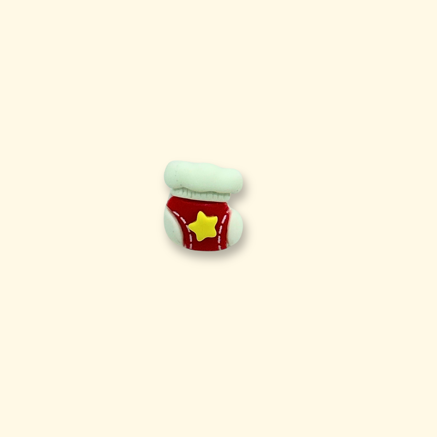Close-up of a red Christmas stocking accessory with a yellow star for pet collars