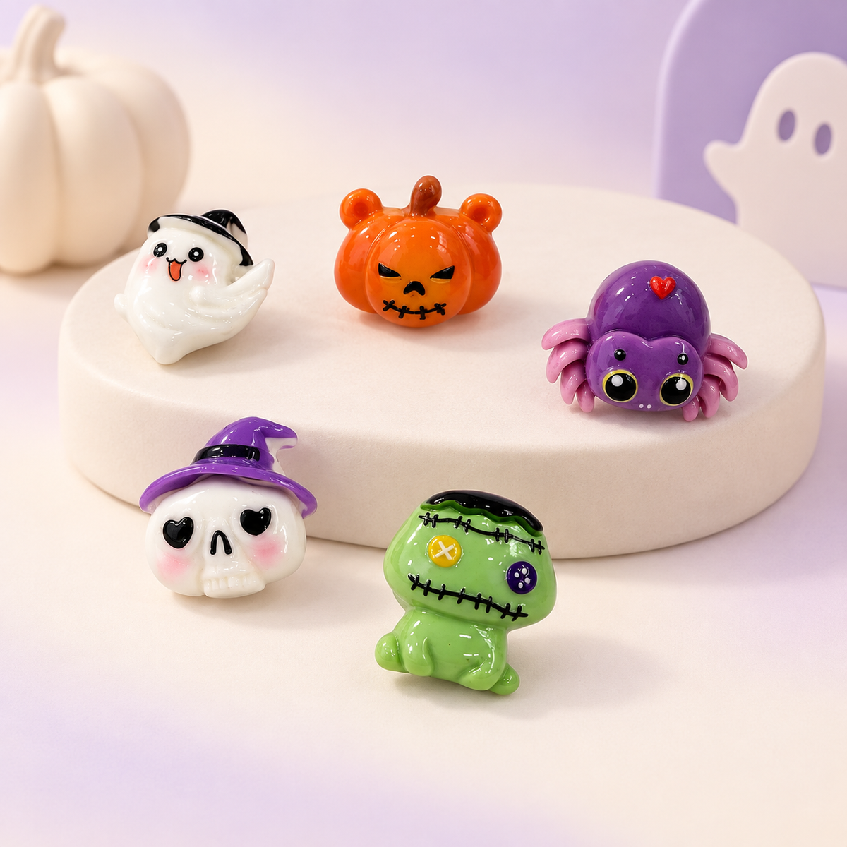 Halloween dog collar charms featuring a ghost, jack-o-lantern, purple spider, witch hat skull and stitched monster