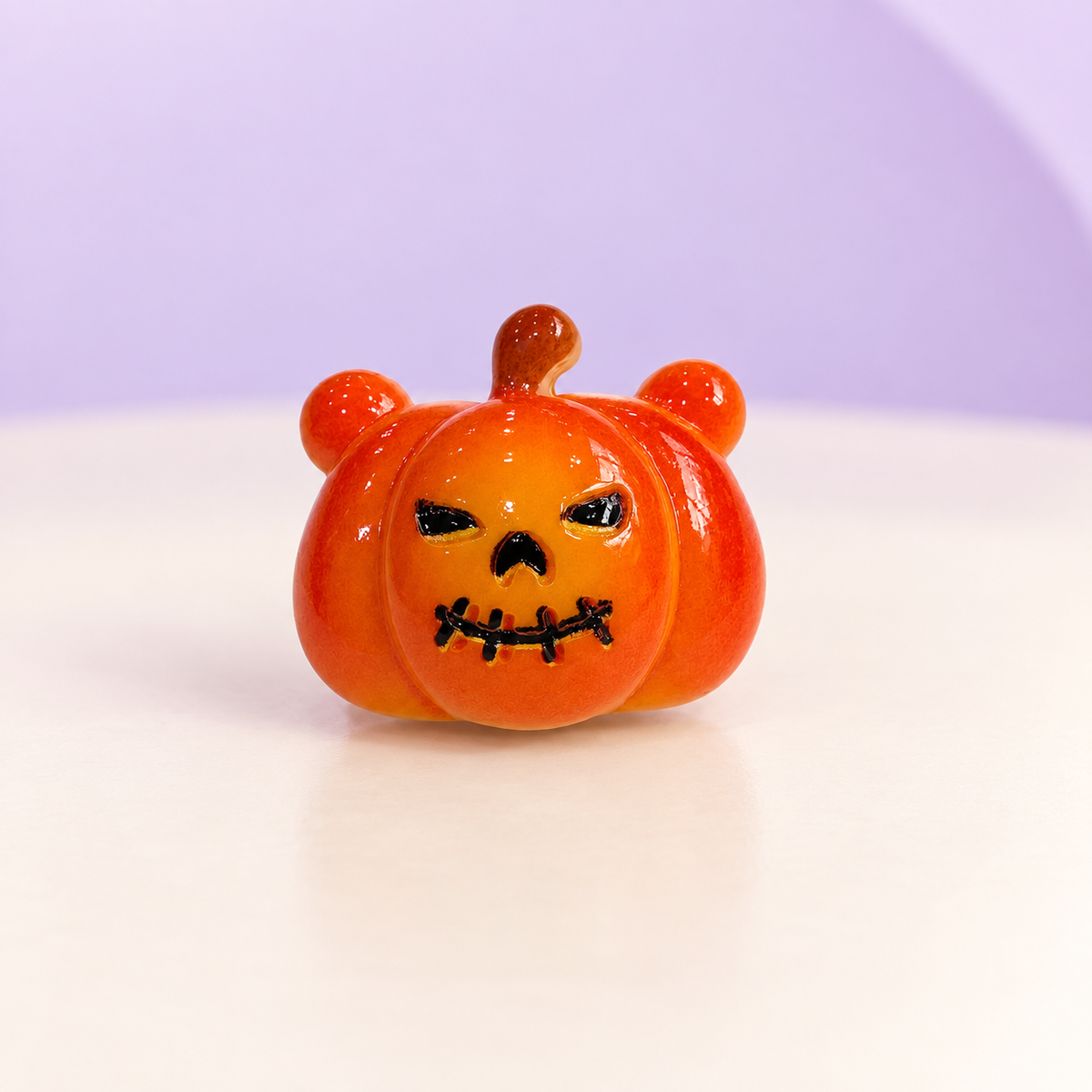 Orange pumpkin dog collar charm with a spooky jack-o-lantern face for Halloween