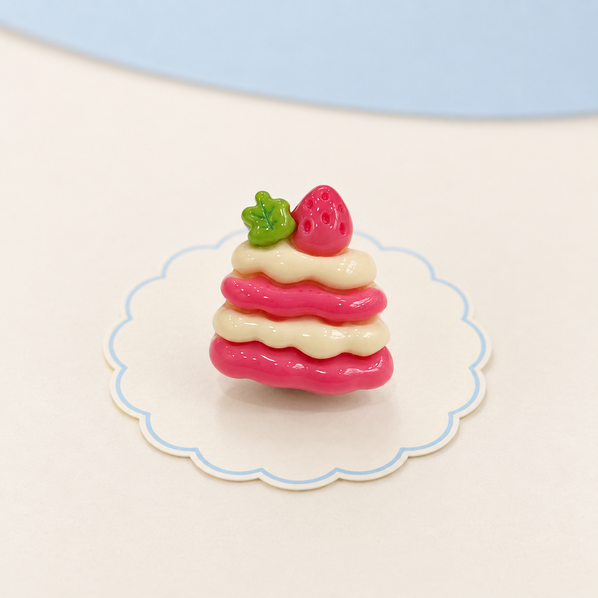 Strawberry layer cake dog collar charm with pink cake layers, cream filling and strawberry topping