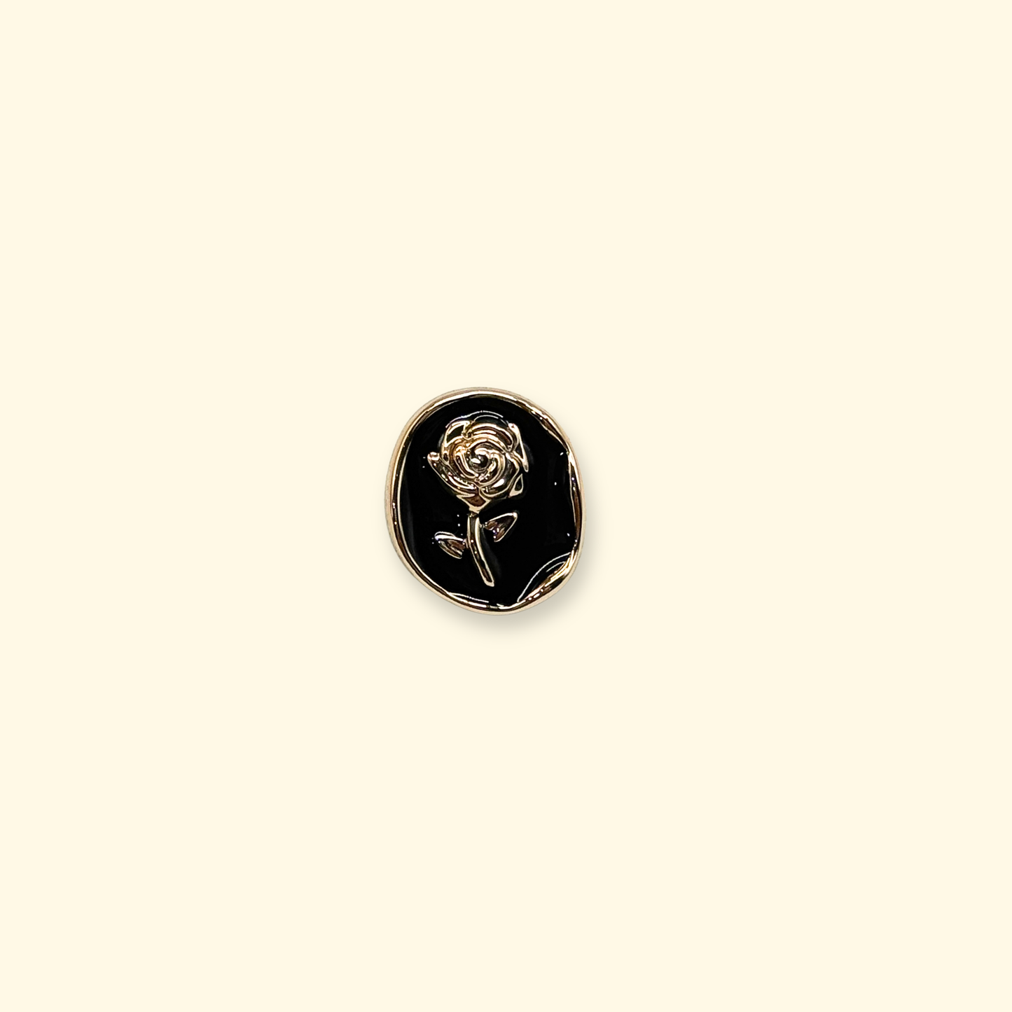 Close-up of Petiria vintage black rose snap-on dog collar charm with gold metal frame.